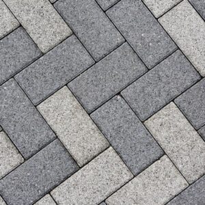 Patio Pavers Design Detailed view of a gray brick sidewalk in South Jordan, Utah, featuring well-kept landscaping