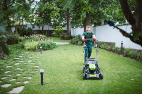 A man performing weekly landscaping services by Thrive Landscape Services